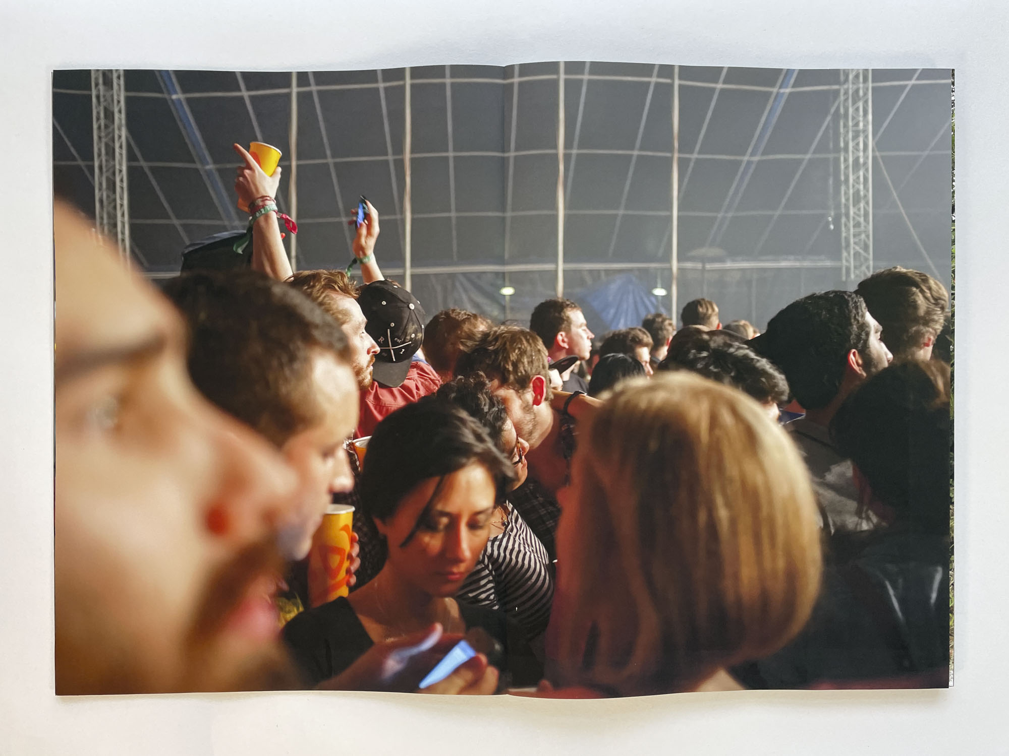 a close-up of a crowd of young people in a marquee at a rave