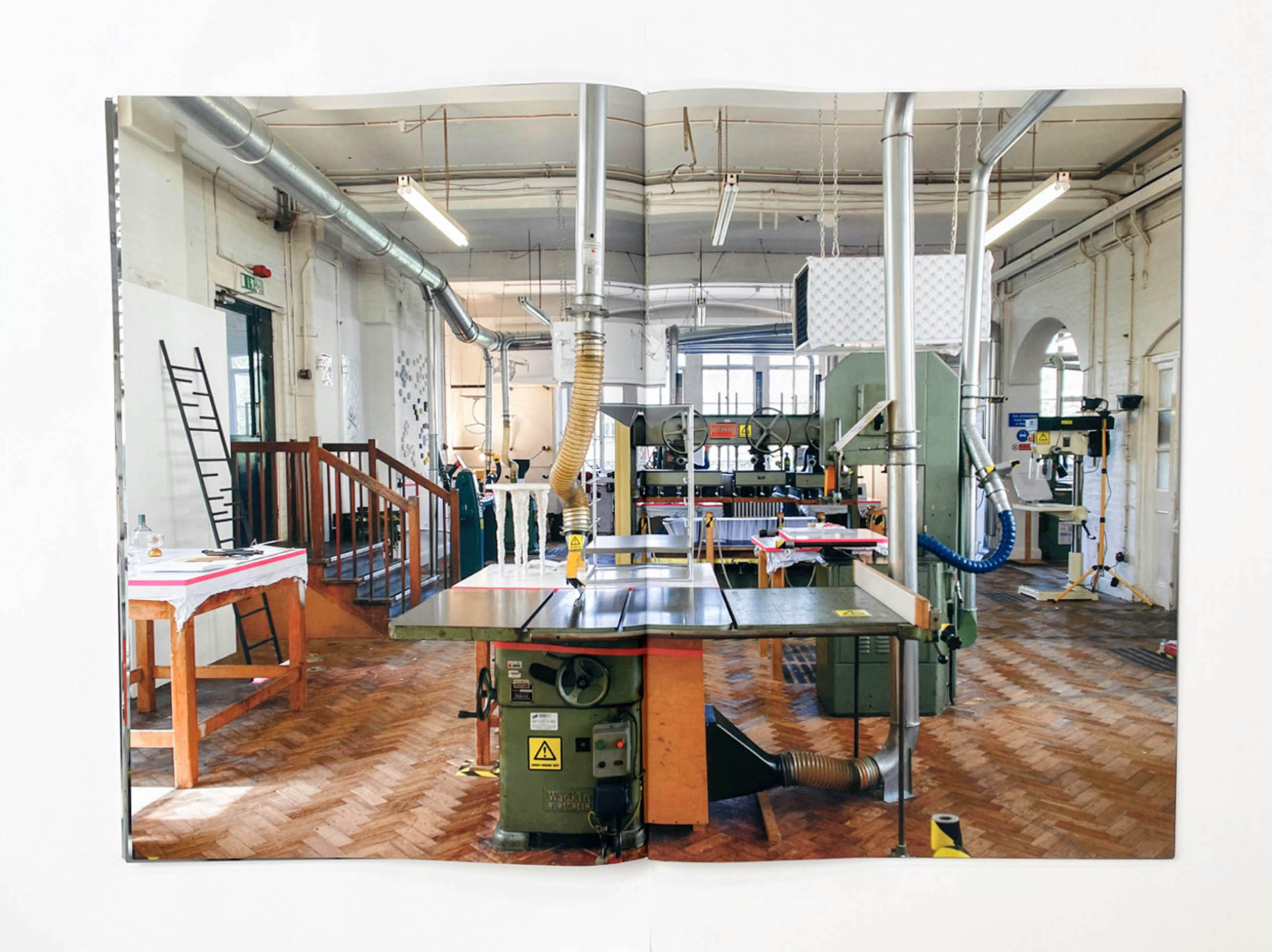 a large room with a parquet floor is filled with industrial machinery