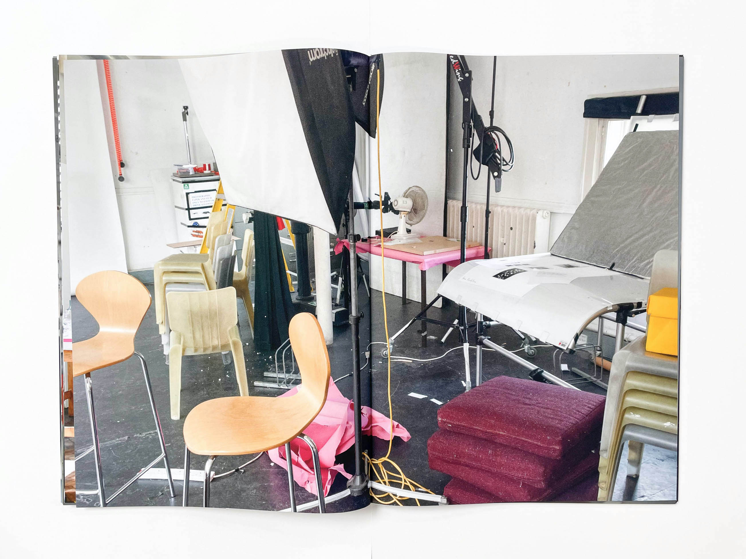 a chaotic photographic studio filled with chairs and equipment