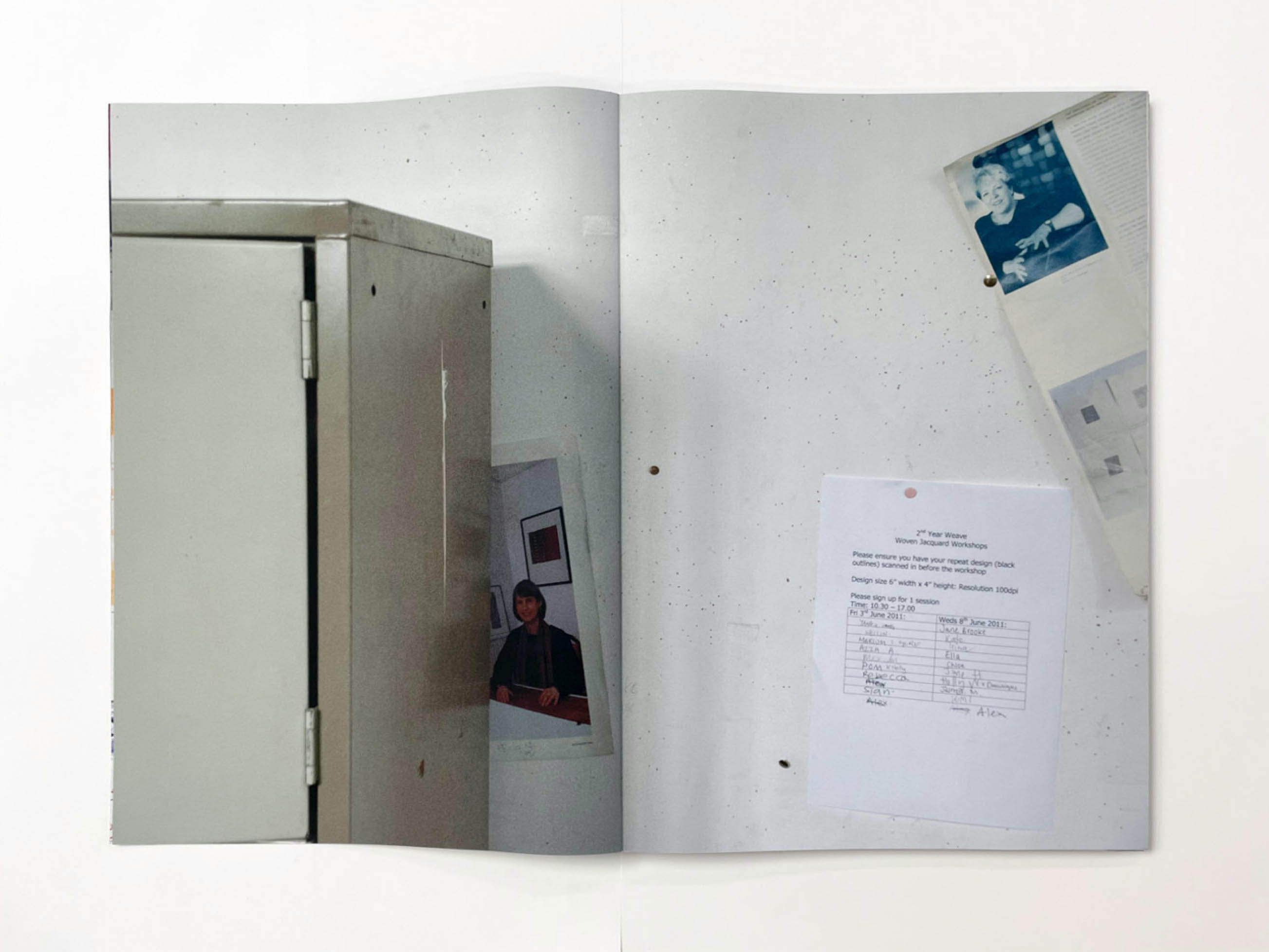 a wall with some papers pinned to it, a picture is partly hidden by a metal filing cabinet