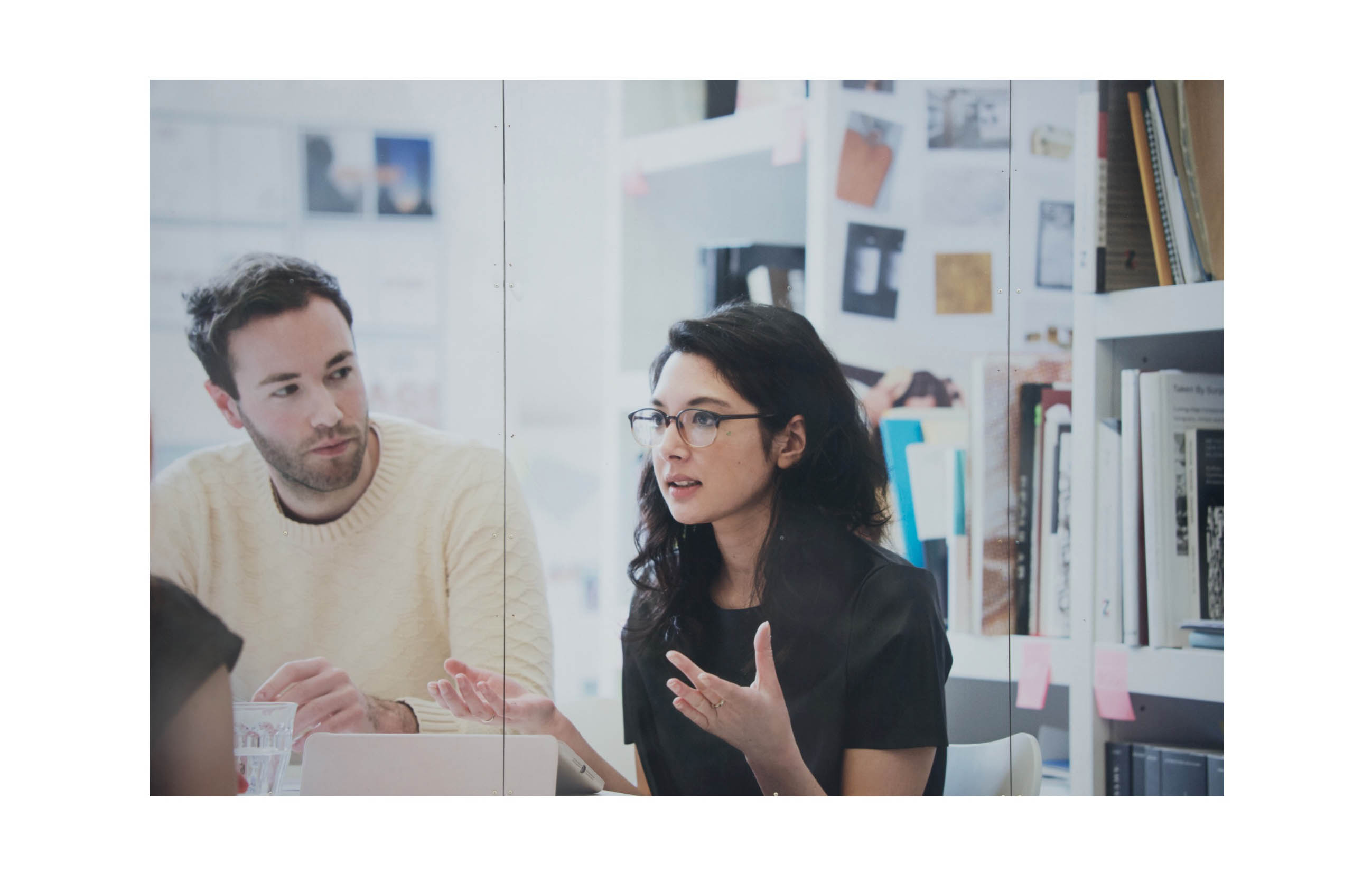 Two middle class young people discussing something in an office