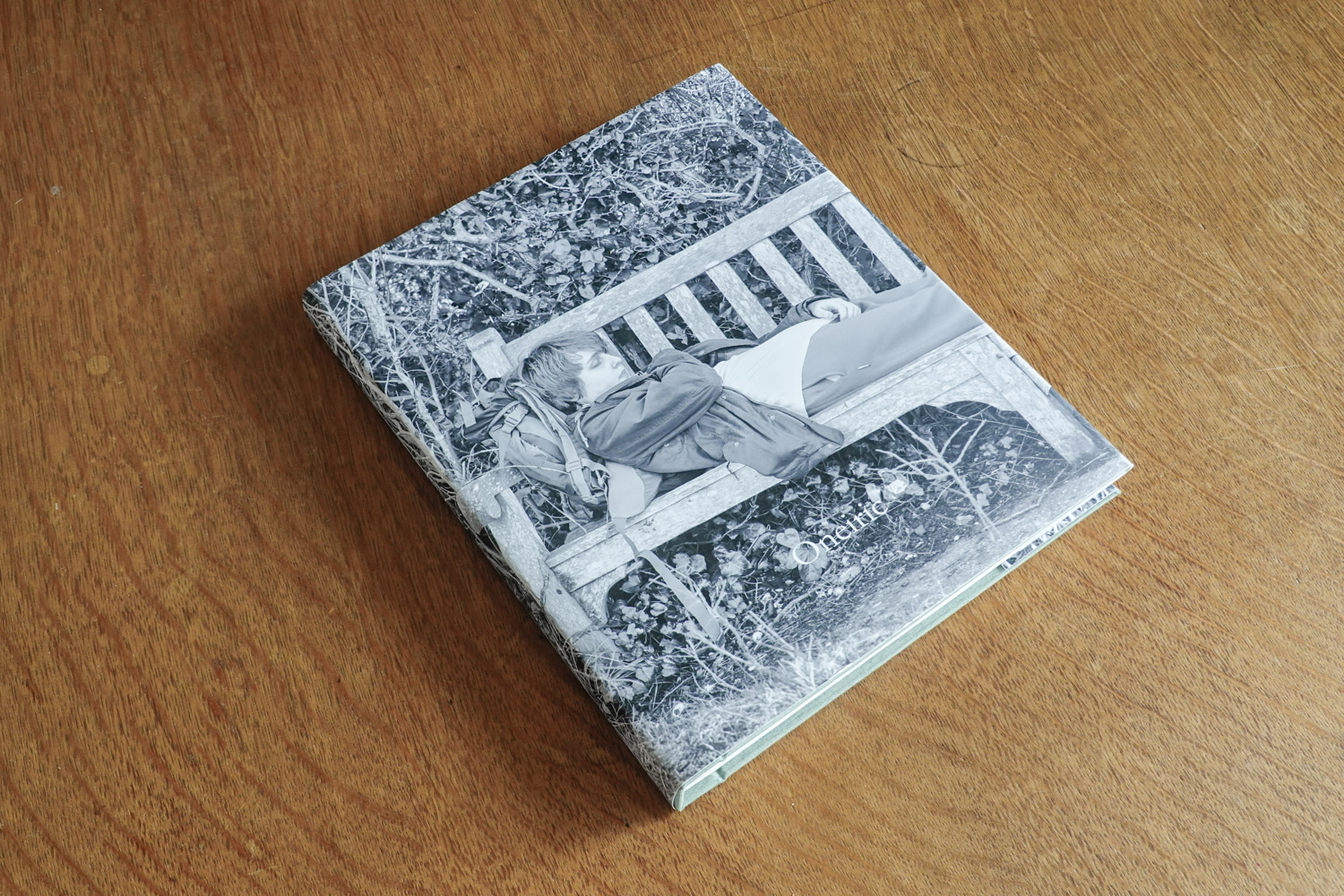 Photo of the book Oneiric sitting on a wooden table top