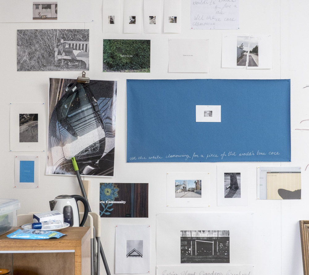 A wall with many different photographs pinned to it