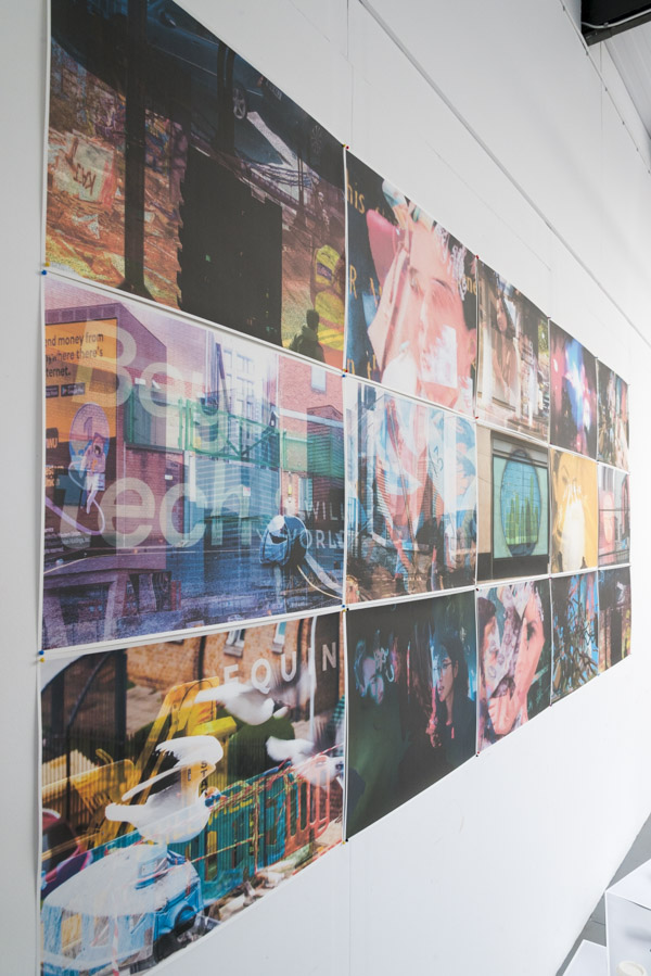 an oblique view from the left of the grid of multilayered images pinned to the white wall