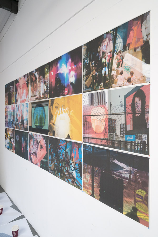 an oblique view from the right of the grid of multilayered images pinned to the white wall