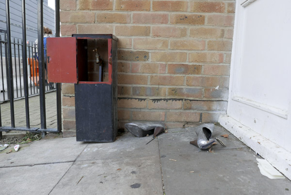 a pair of cheap silver high heeled shoes lie discarded in the doorway